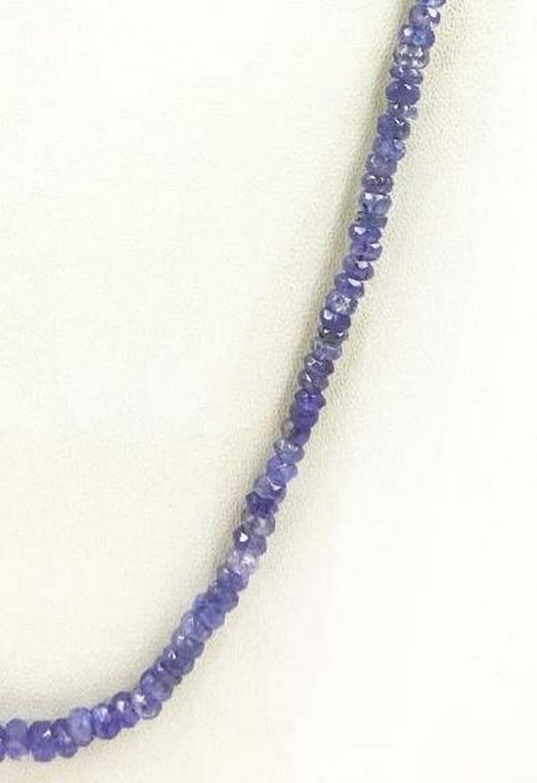 18" Tanzanite Faceted String Beaded Necklace: 18" Tanzanite Faceted String Beaded Necklace Introducing our 18" Tanzanite Faceted String Beaded Necklace, a radiant accessory that seamlessly combines sophistication with timeless allure.