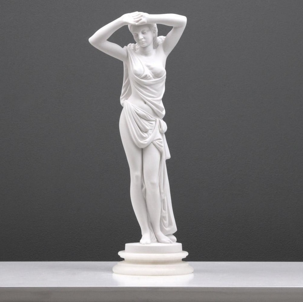 Young Beauty Posing In Toga Sculpture - (2.4lbs): Young Lady Posing in Clothes Sculpture - (2.4lbs) This sculpture portrays a young lady in a toga captured in the act of stretching after bathing. Crafted from white bonded marble, this artwork
