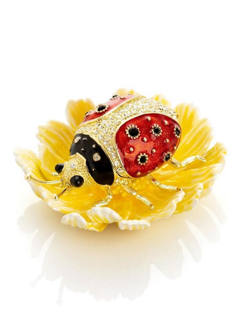 Whimsical Ladybug Flower Trinket Box: Whimsical Ladybug Flower Trinket Box This enchanting trinket box brings a playful touch of nature-inspired elegance to any space. A vibrant red enamel ladybug rests atop a sculpted yellow flower,