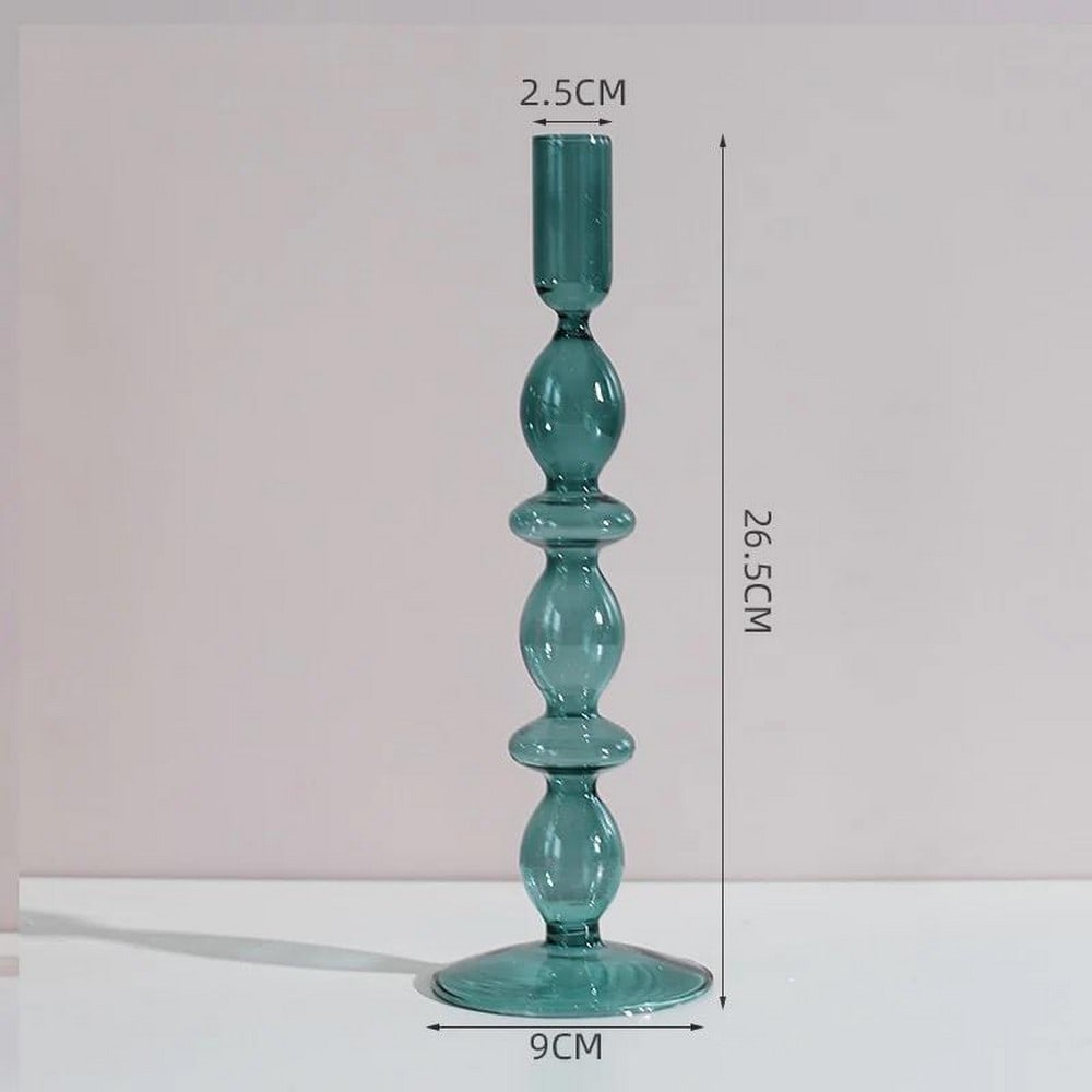 10.4" Milan Green Glass Candle Holder: 10.4" Milan Green Glass Candle Holder Introducing our 10.4" Milan Green Glass Candle Holder, a captivating addition to elevate your home decor. This exquisite candle holder exudes a sense of