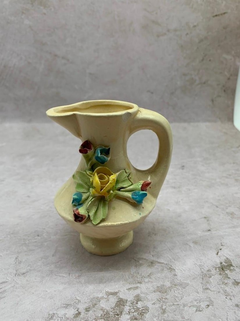Vintage Bassano Porcelain Creamer with Sculpted Floral Detail: Vintage Bassano Porcelain Creamer with Sculpted Floral Detail Add a touch of Italian charm to your table with this vintage Bassano porcelain creamer. Finished in a soft cream tone, this elegant