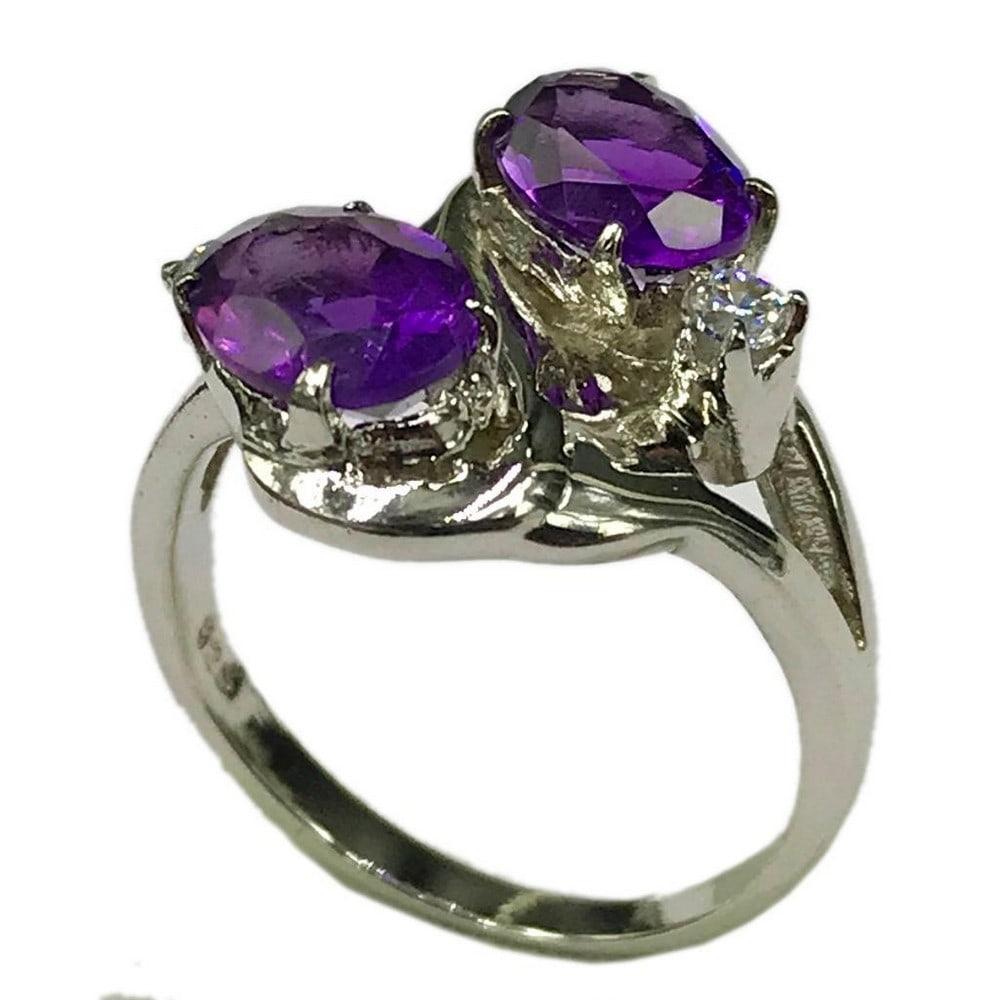 2 Amethyst Stone Sterling Silver Ring: 2 Amethyst Stone Sterling Silver Ring This ring is studded with zirconias and 2 beautiful amethyst gemstones. Inner Diameter: 17.35mm View Photos For Further Details.