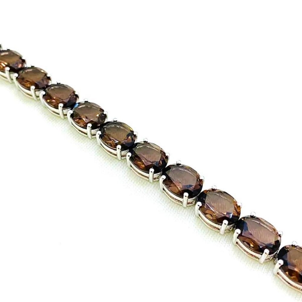 Brown Smoky Quartz Studded Bracelet: Brown Smoky Quartz Studded Bracelet This bracelet is 925 Sterling Silver and features stunning brown smoky quartz faceted ovals. Size of Gemstones: 10x8mm View Photos For Further Details