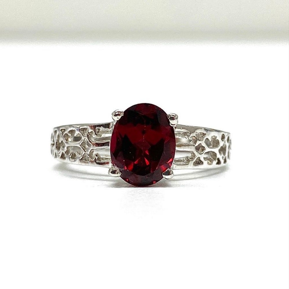 Large Garnet Gemstone on an Intricate 925 Sterling Silver Band: Large Garnet Gemstone on an Intricate 925 Sterling Silver Band. Garnets symbolize love and friendship. They represent the heart, inner fire, and are considered to be a life force. Garnets are also