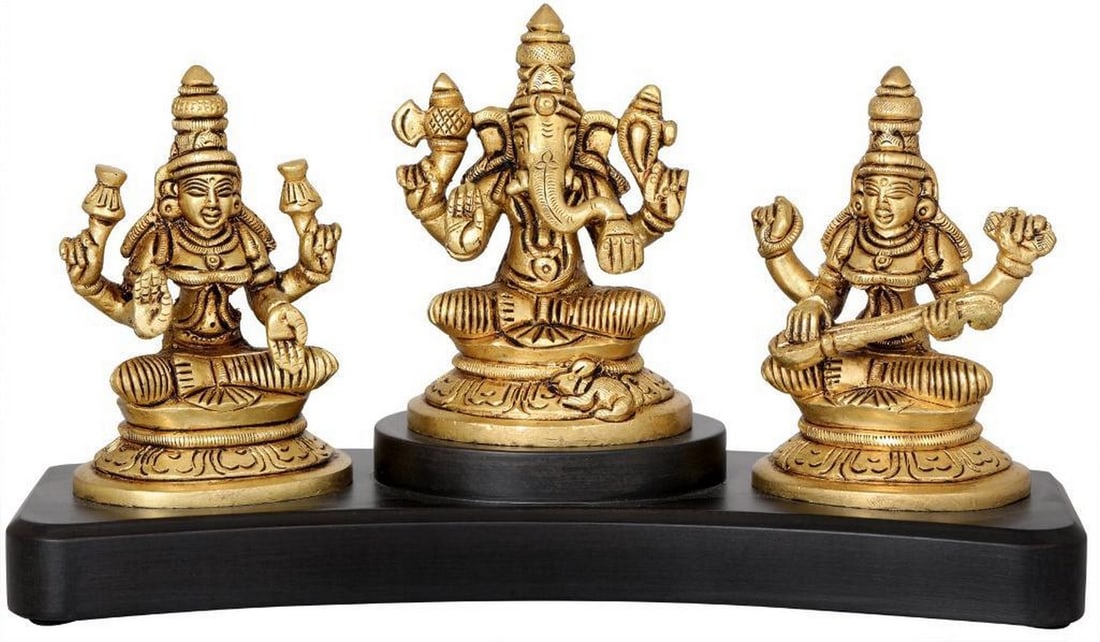 Brass Lakshmi, Ganesha & Saraswati Mini Idol – 4": Brass Lakshmi, Ganesha & Saraswati Mini Idol – 4" This 4" brass statue depicts the revered trinity of Lakshmi, Ganesha, and Saraswati, representing prosperity, wisdom, and the removal o