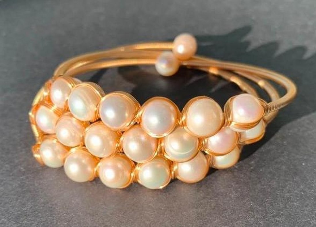 Wrap Bracelet with Pearl Accents: Wrap Bracelet with Pearl Accents Elevate your accessory game with this gold-toned wrap bracelet, elegantly accented with pearls. Designed to wrap around your wrist multiple times, it creates a layere