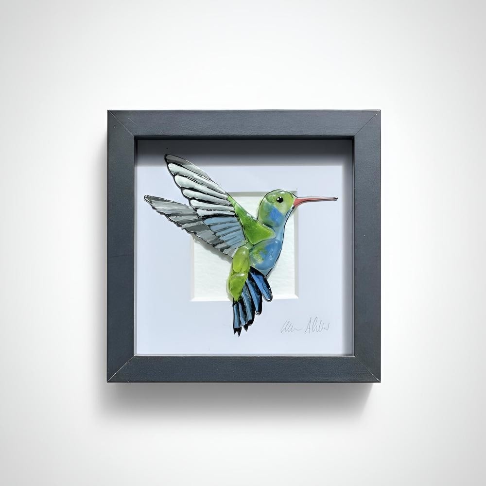 Sea Glass Art ‘Hummingbird’ by Sea on Glass: Sea Glass Art ‘Hummingbird’ by Sea on Glass This framed artwork features a delicately composed hummingbird, created using hand-selected sea glass pieces. The natural shapes and soft translucency o
