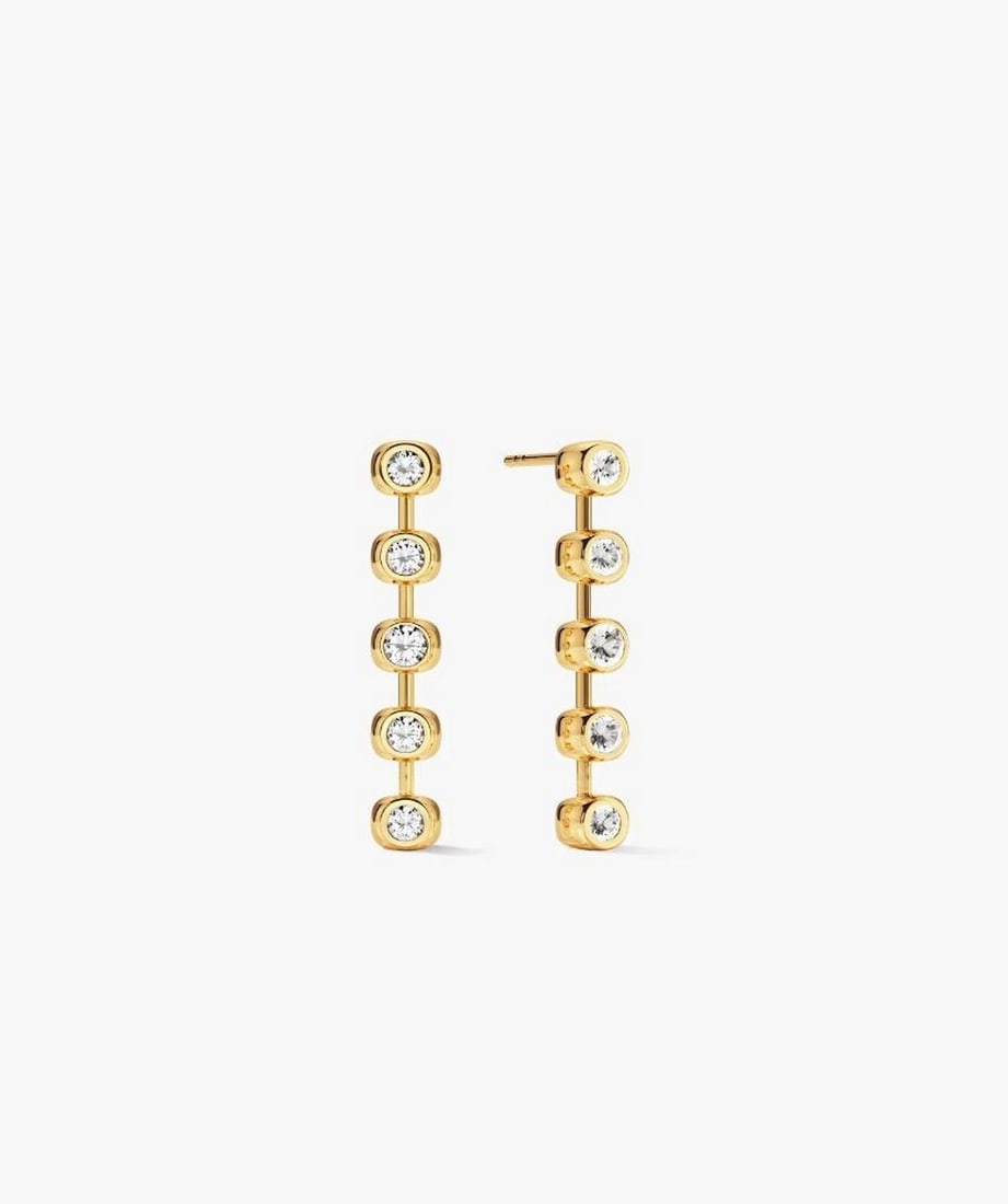 18k Gold Vermeil Lab-Grown White Sapphire Tennis Earrings: 18k Gold Vermeil Lab-Grown White Sapphire Tennis Earrings A pair of drop earrings featuring a continuous line of lab-grown white sapphires set along a delicate gold vermeil base. Lightweight and vers