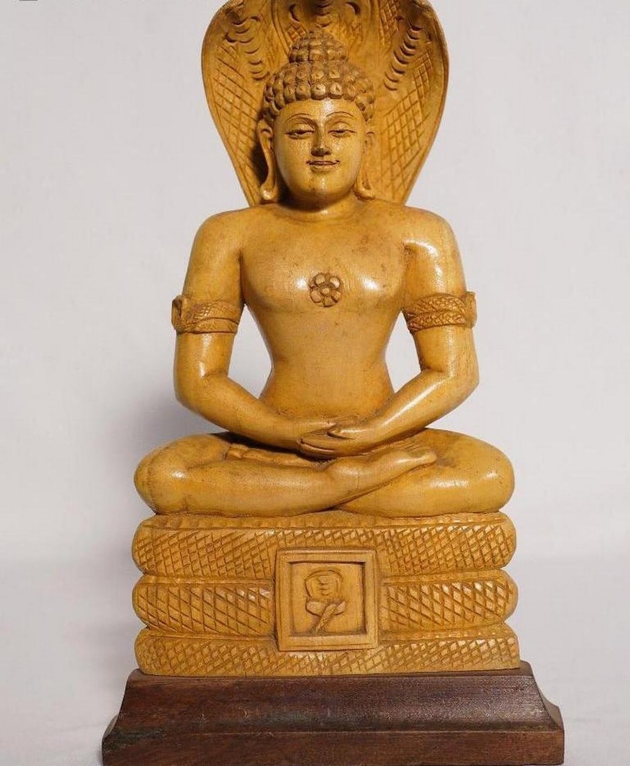 11" Lord Parshwanath Sculpture Handmade White Wood Figurine: 11" Lord Parshwanath Sculpture Handmade White Wood Figurine This finely handcrafted sculpture features Lord Parshwanath, the twenty-third Tirthankara of Jainism, carved from smooth white wood.