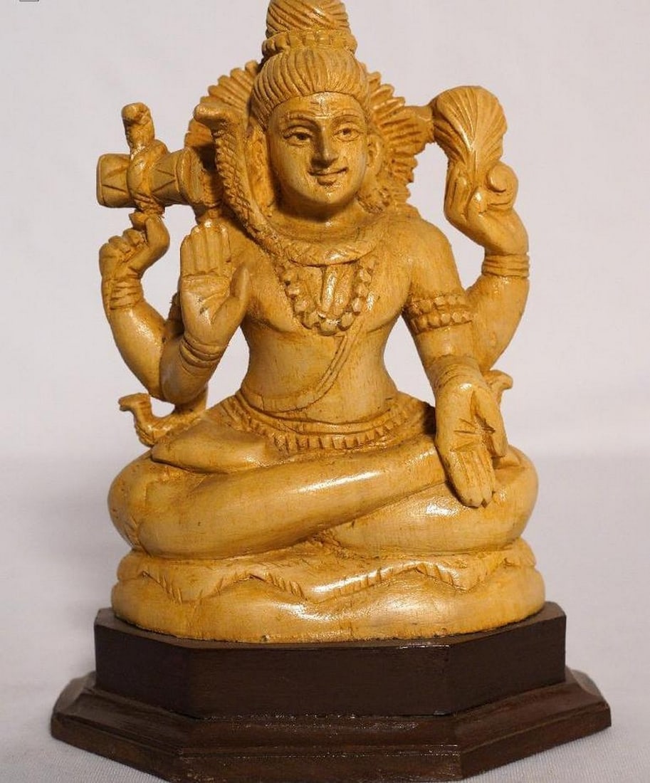 8" Lord Shiva Seated in Blessing Posture Handmade White Wood Figurine: 8" Lord Shiva Seated in Blessing Posture Handmade White Wood Figurine This finely handcrafted figurine depicts Lord Shiva seated in a blessing posture (Abhaya Mudra), symbolizing protection,