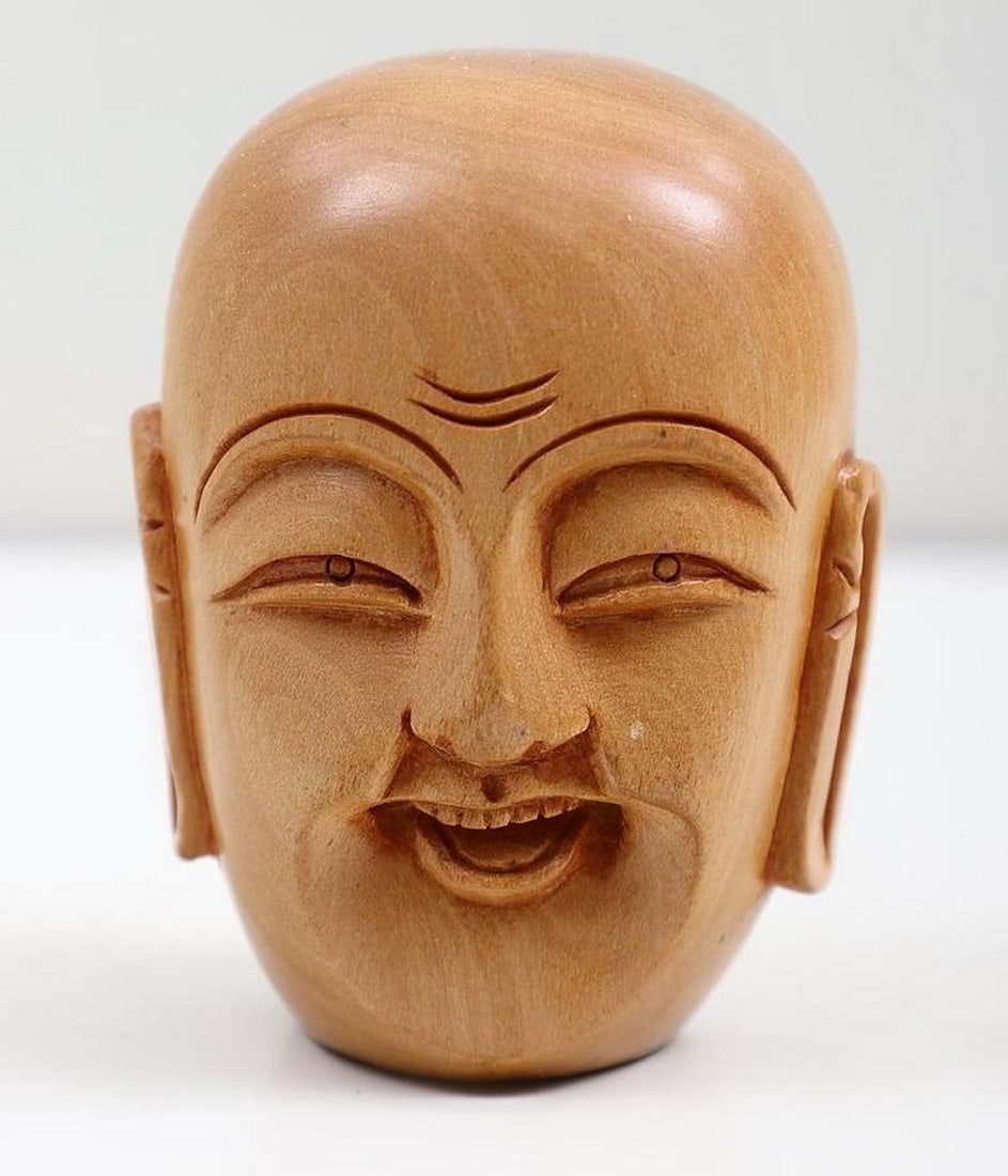 Wooden Laughing Buddha Head Mini Statue – 3": Wooden Laughing Buddha Head Mini Statue – 3" This 3" wooden statue depicts the Laughing Buddha, a timeless symbol of joy, contentment, and prosperity. Hand-carved with a cheerful