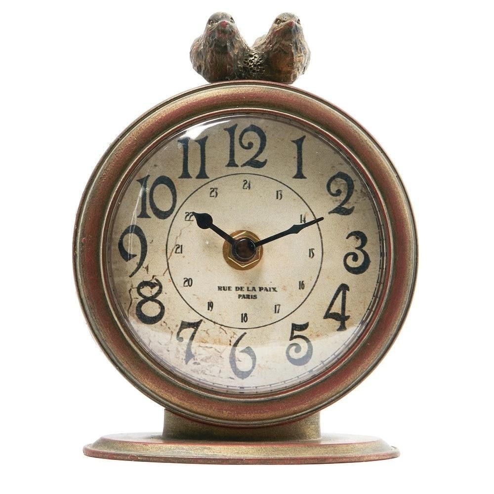 Pewter Bird Mantel Clock: Pewter Bird Mantel Clock This charming pewter mantel clock features a vintage, distressed look with two birds perched on top, adding a whimsical touch to any space. The clock face displays Arabic