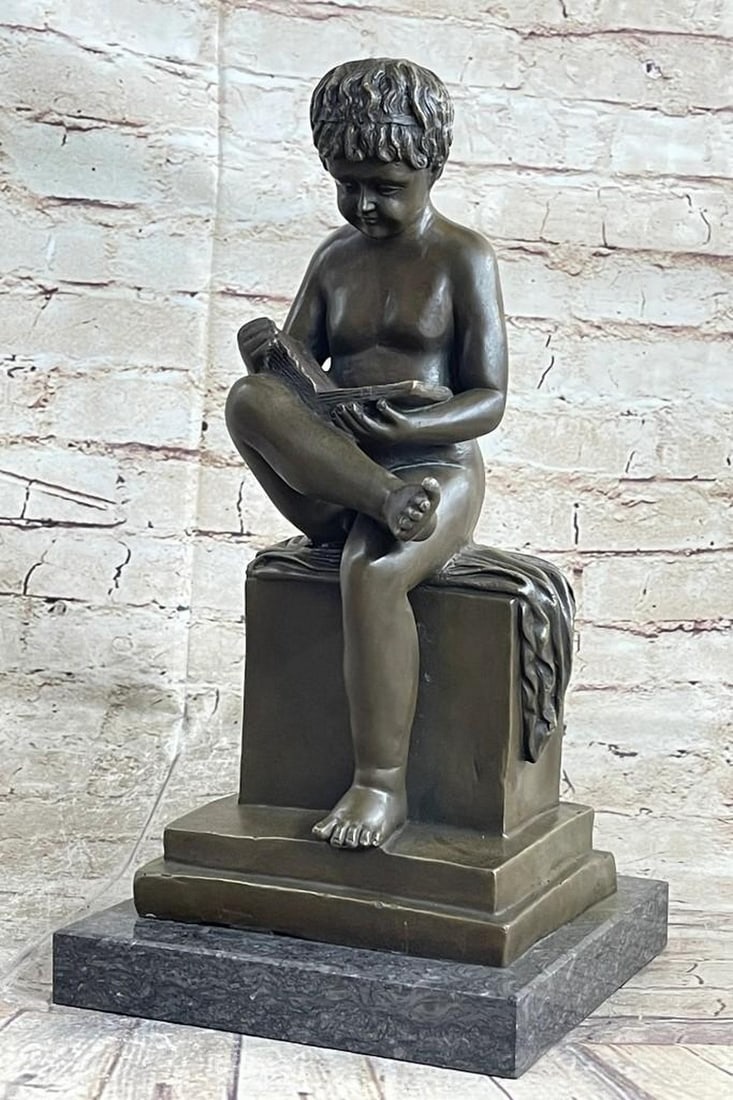 Young Boy Reading Bronze Sculpture: Young Boy Reading Bronze Sculpture What a joy it is to see young Boy enjoy a book! This sweet little boy stands smartly with a book on her lap. He is entranced in the novel that is coming to life in