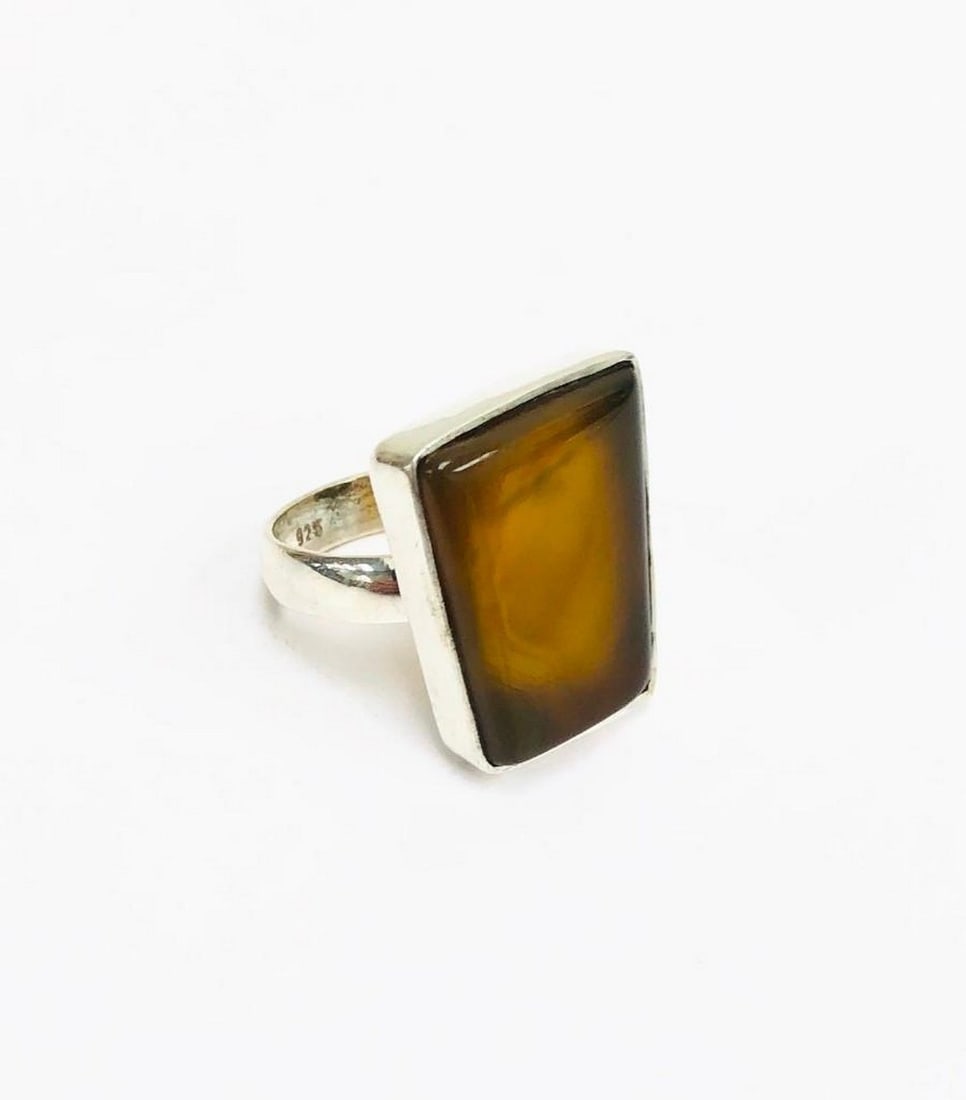 Golden Gaze Sterling Stone Ring: Golden Gaze Sterling Stone Ring Crafted in genuine 925 sterling silver, this striking ring features a polished Tiger’s Eye gemstone that displays its signature golden-brown bands and mesmerizing ch
