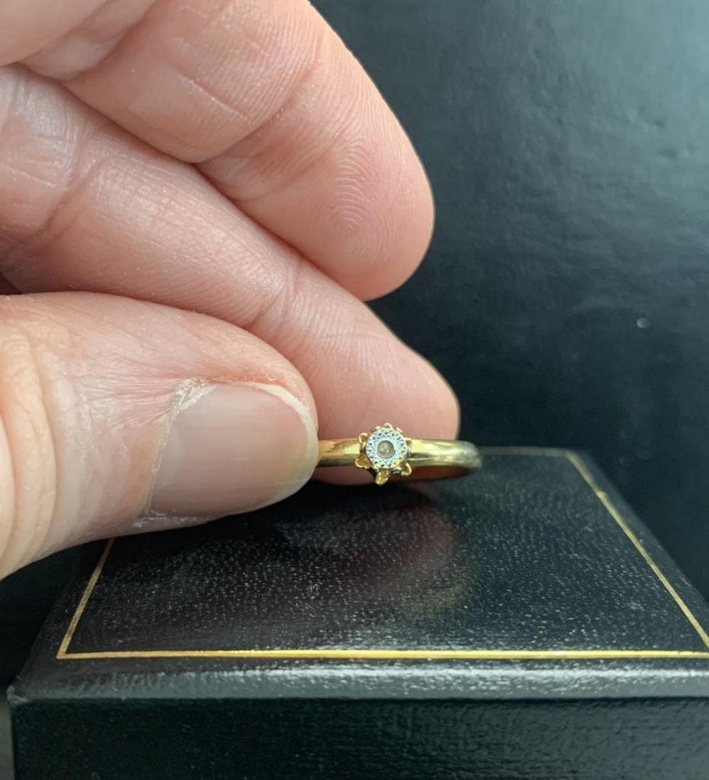 Gold Plated Band with Intricate Silver-Tone Carved Detail: Gold Plated Band with Intricate Silver-Tone Carved Detail Add a touch of refined elegance to your jewelry collection with this beautiful gold-plated ring featuring a striking silver-toned center