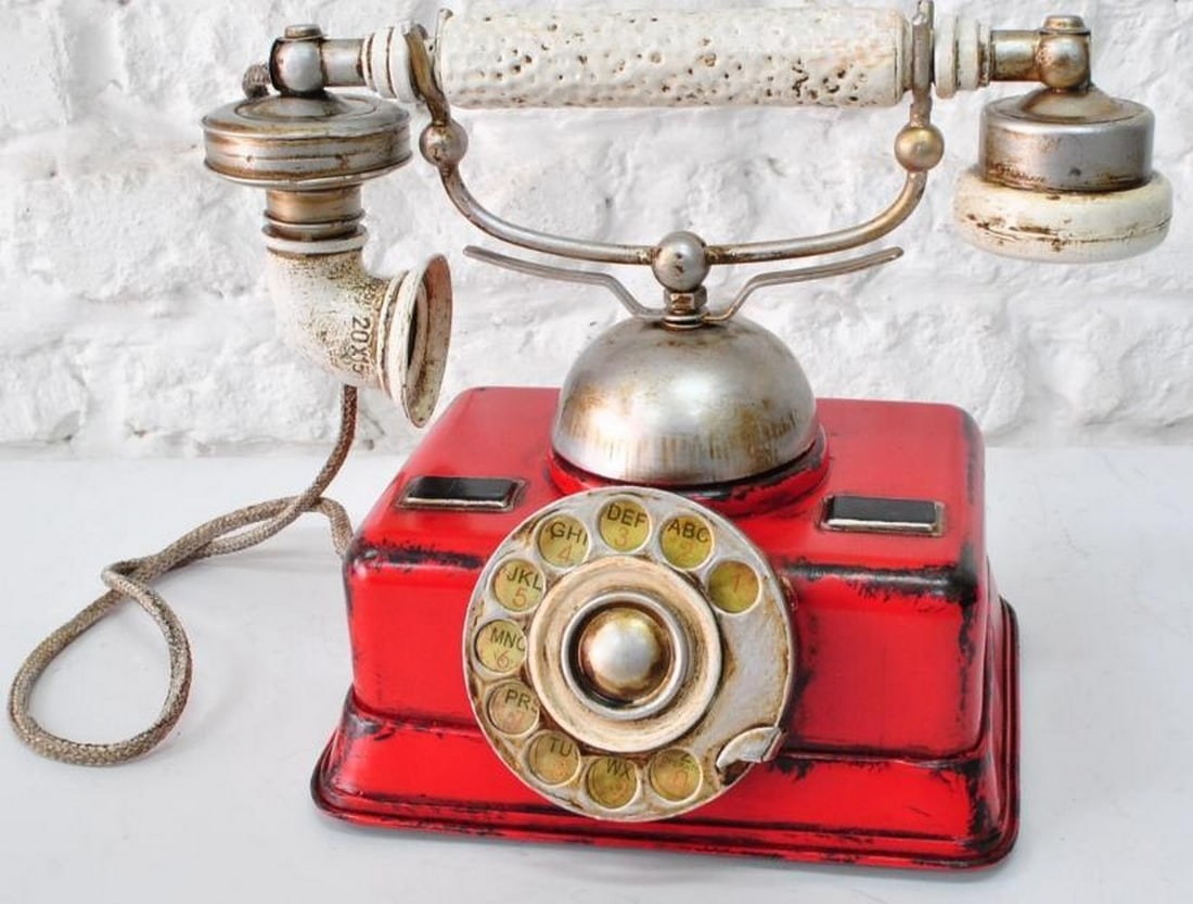 Red German Rotary Dial Phone Sculpture: Red German Rotary Dial Phone Sculpture This stunning antique reproduction of a German rotary dial phone serves as both a nostalgic sculpture and a unique piece of decor. Crafted from durable plastic