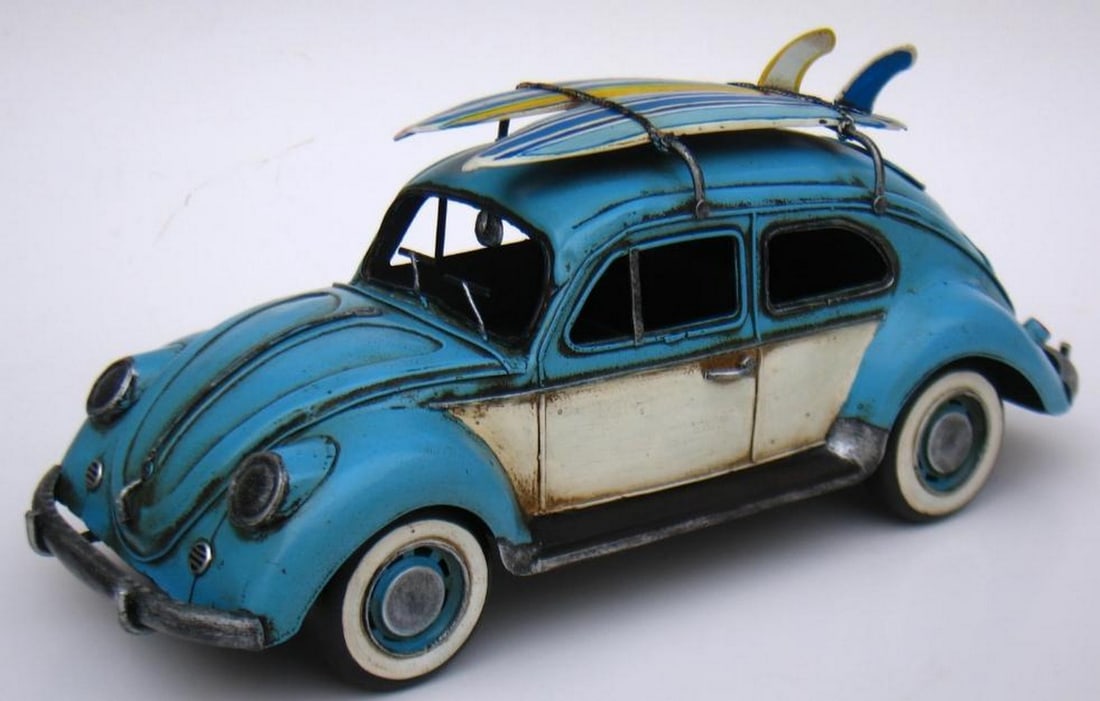 Surfin' Classic: 1934 VW Beetle with Surfboards: Surfin' Classic: 1934 VW Beetle with Surfboards This nostalgic figurine of a 1934 VW Beetle, finished in a cool light blue, captures the carefree spirit of vintage road trips and beachside