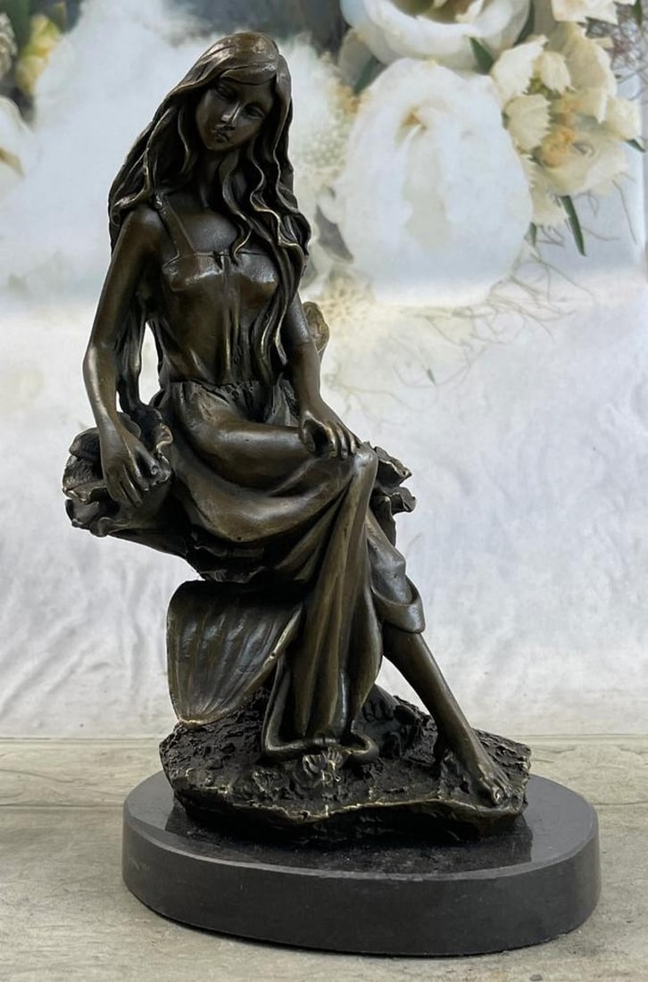 Nymph Girl Sitting on Flower Original Bronze Statue - 9" x 5": Nymph Girl Sitting on Flower Original Bronze Statue - 9" x 5" Amidst a serene flower garden, a woman sits gracefully on a rock, holding a bouquet in hand. Her elegant dress subtly reveals her