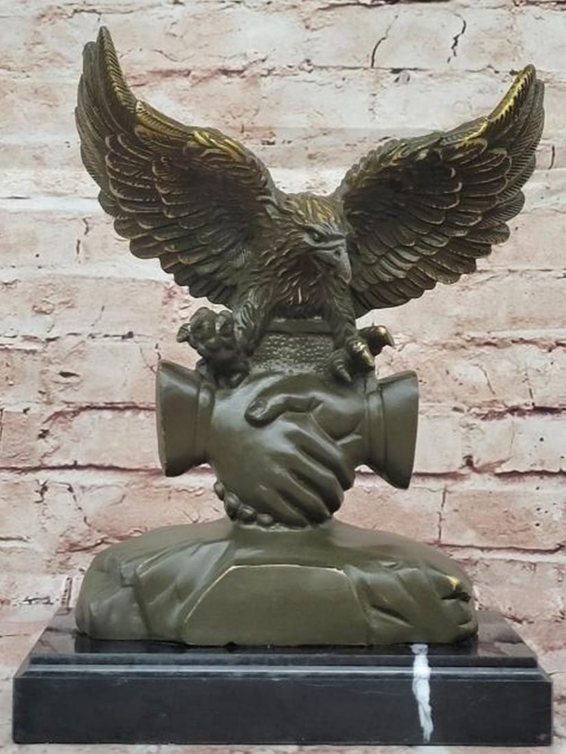 Bronze Eagle and Handshake Statue: Bronze Eagle and Handshake Statue This powerful Bronze Eagle and Handshake Statue, inspired by the artistry of M. Lopez, embodies the ideals of unity, strength, and mutual respect. The sculpture feat