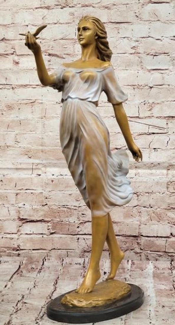 Bronze Elegance: Woman with Bird Sculpture: Bronze Elegance: Woman with Bird Sculpture A mesmerizing fusion of beauty and symbolism, this Bronze Woman with bird sculpture captures a moment of serene elegance and connection to nature. The figur