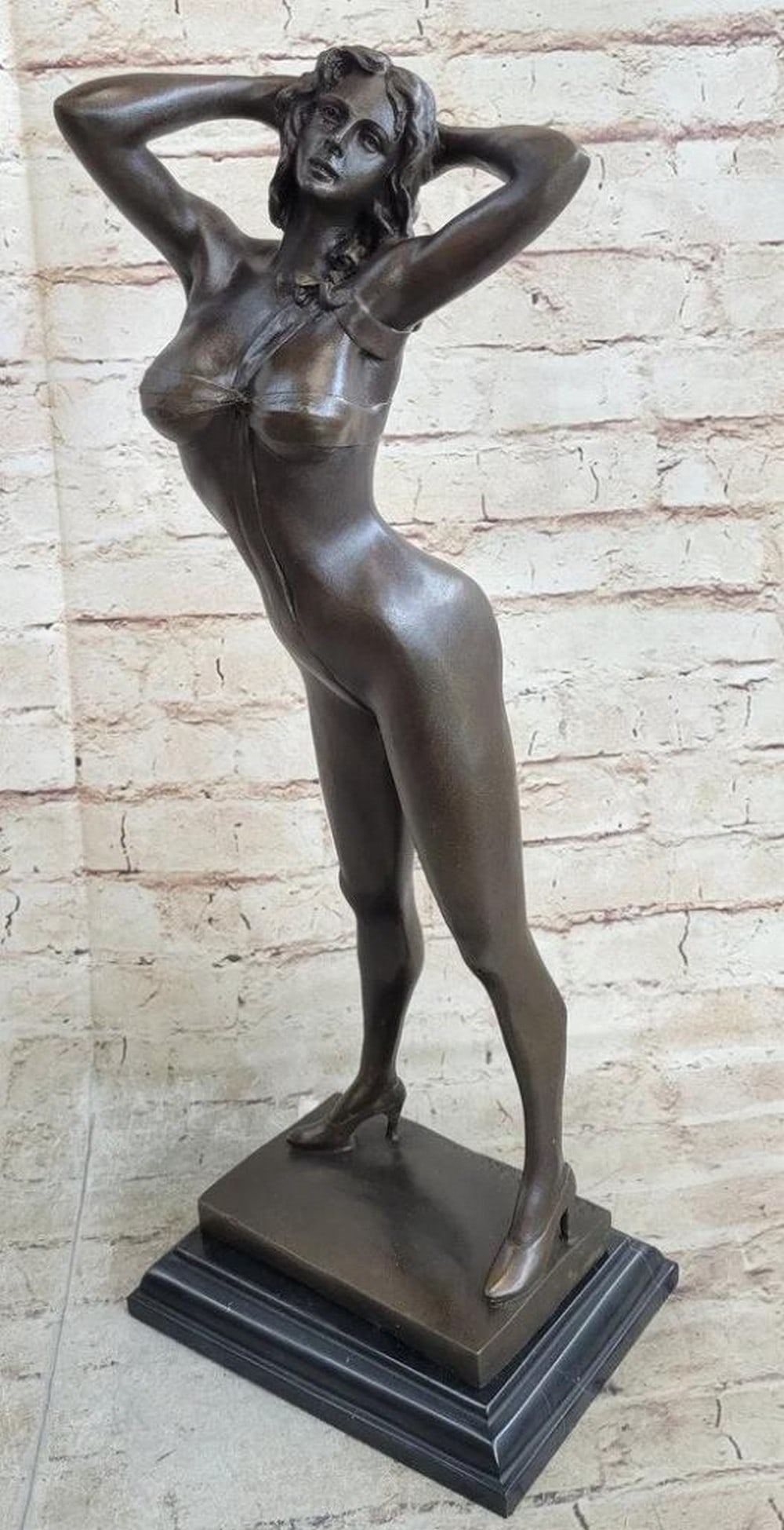 Sexy Girl Bronze Sculpture: Sexy Girl Bronze Sculpture This striking bronze sculpture captures the iconic allure of a Playboy Bunny centerfold in a dynamic and seductive pose. The female figure stands confidently with her back