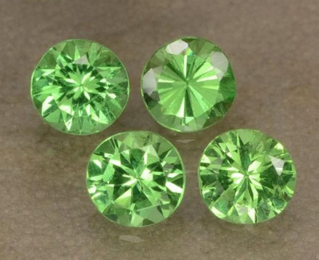 0.93 ct Round Diamond-Cut Lively Green Tsavorite Garnet Gemstones: 0.93 ct Round Diamond-Cut Lively Green Tsavorite Garnet Gemstones Introducing our set of four natural Tsavorite Garnet gemstones, totaling 0.93 ct, each crafted in a round diamond cut to showcase
