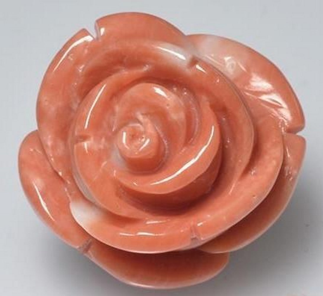 Coral Gemstone Medium Pink Hand-Carved Rose: Coral Gemstone Medium Pink Hand-Carved Rose Delicately crafted from natural coral, this loose gemstone features a beautifully detailed rose carving in a soft medium pink hue. Each petal is skillfully