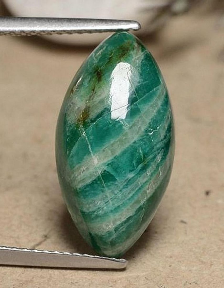 7.42 ct Natural Medium Green Amazonite – Marquise Cabochon: 7.42 ct Natural Medium Green Amazonite – Marquise Cabochon Introducing the Natural Medium Green Amazonite, a striking gemstone that brings a serene and refreshing touch to your jewelry collection.