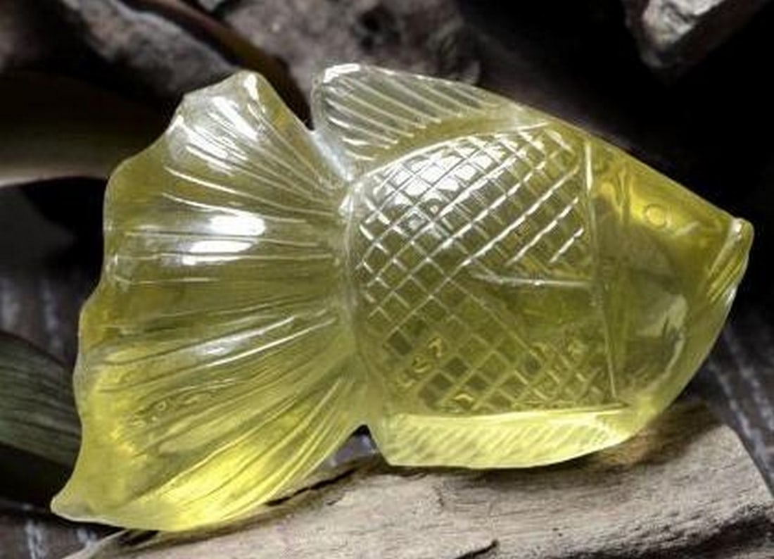 Lemon Yellow Quartz Fish Carving: Lemon Yellow Quartz Fish Carving Graceful and vibrant, this gemstone fish carving is crafted from luminous lemon yellow Quartz, capturing the playful spirit and fluidity of aquatic life. Expertly