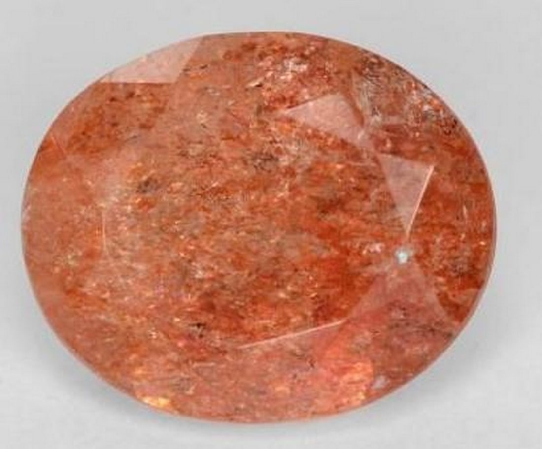 Loose Oval-Cut Sunstone: Loose Oval-Cut Sunstone Capture the warmth of the sun with this loose sunstone gemstone, beautifully cut in an elegant oval facet shape. Known for its shimmering aventurescence, this sunstone