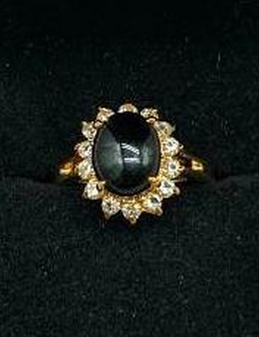 Black Onyx Solitaire Crown Ring with White Crystal Accents: Black Onyx Solitaire Crown Ring with White Crystal Accents Bold elegance meets timeless design in this striking ring, featuring a round black onyx stone set in a regal solitaire crown setting. The ri