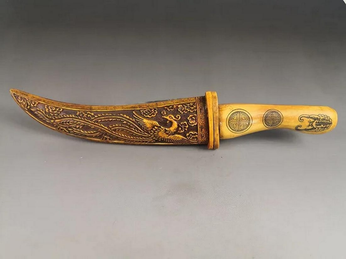 Ancient Chinese Hand-Carved Buffalo Bone Knife with Dragon and Phoenix: Ancient Chinese Hand-Carved Buffalo Bone Knife with Dragon and Phoenix This exquisite ancient Chinese knife is meticulously hand-carved, showcasing the legendary Dragon and Phoenix, powerful