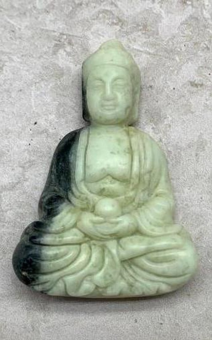 Buddha’s Serenity White Stone Pendant: Buddha’s Serenity White Stone Pendant This stunning pendant is carved from a smooth white stone, with subtle black markings that add depth and character to its serene design. It features a