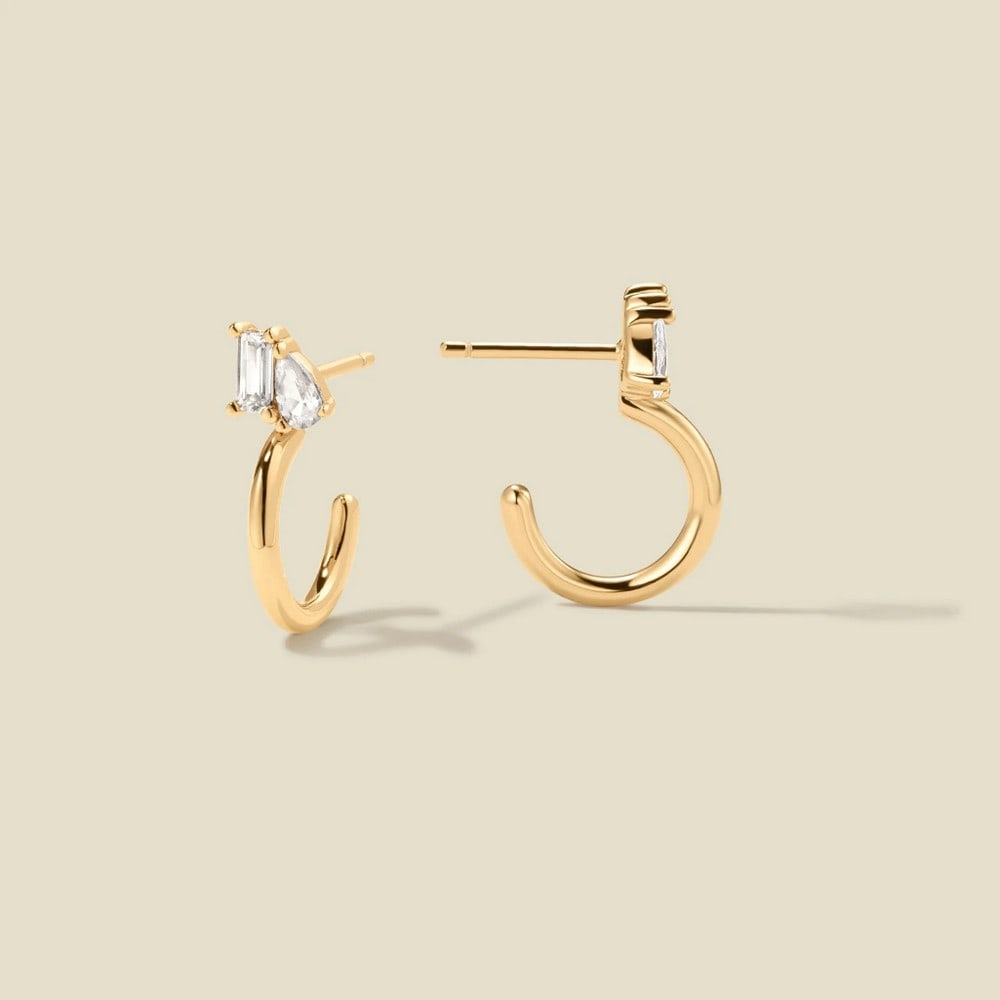 Vermeil Gold & CZ Toi et Moi Hoop Earrings: Vermeil Gold & CZ Toi et Moi Hoop Earrings Cherish every moment with a timeless keepsake. These stud-style hoops, featuring emerald and pear CZs in perfect harmony, add a romantic touch to your