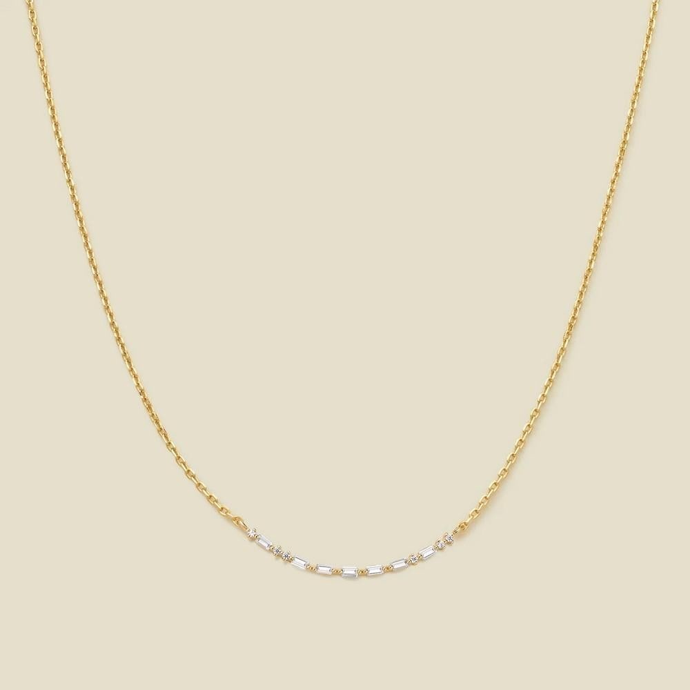 Crescent Morse Code Gold Vermeil Necklace: Crescent Morse Code Gold Vermeil Necklace This elegant crescent necklace is a unique expression of love and connection. Crafted with precision, it features baguette and gem CZs arranged as Morse
