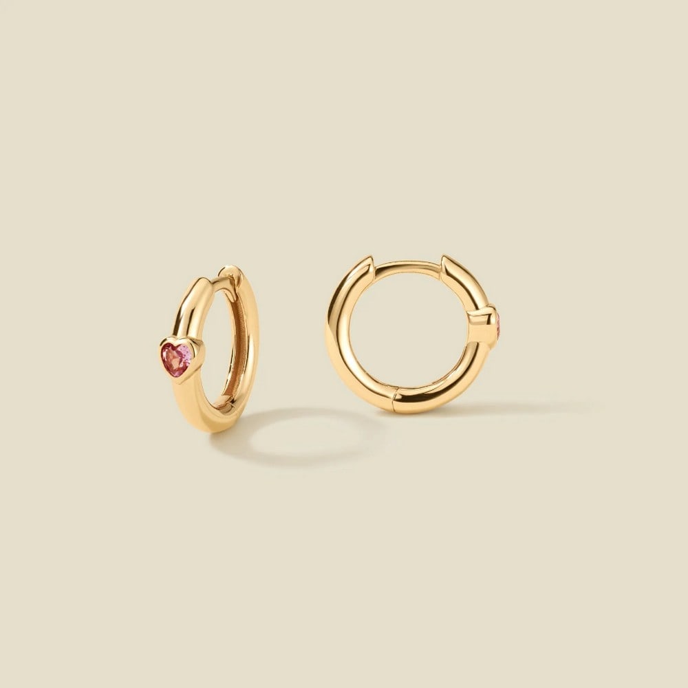 Vermeil Gold & Heart Shaped Pink CZ Huggie Hoop Earrings: Vermeil Gold & Heart Shaped Pink CZ Huggie Hoop Earrings Embrace effortless romance with these gold huggie hoops, adorned with dreamy pink CZ hearts and a secure hinge closure. A timeless