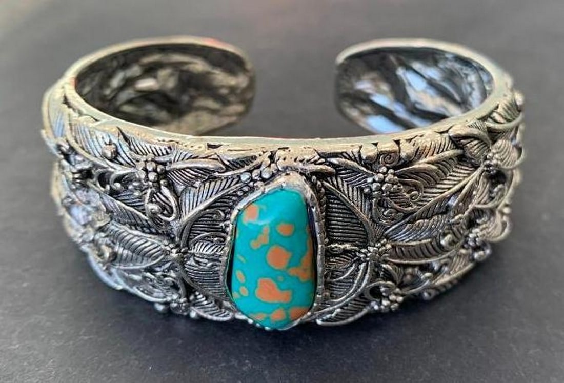 Tibetan Silver Carved Bangle Bracelet: Tibetan Silver Carved Bangle Bracelet This Tibetan silver bangle bracelet features a striking turquoise stone set at the center, beautifully complemented by intricate carvings that flow throughout