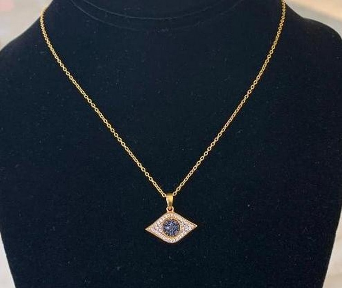 Evil Eye Pendant Necklace: Evil Eye Pendant Necklace This stunning evil eye necklace features a gold-plated sterling silver pendant set with radiant blue and white gemstones for a brilliant protective shine. Perfect as a