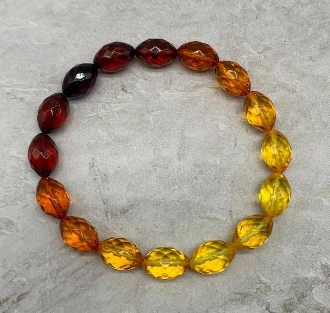 Ombre Amber-Toned Beaded Bracelet: Ombre Amber-Toned Beaded Bracelet Inspired by the warm hues of a setting sun, this ombre-style bracelet features smooth amber-colored beads that transition beautifully from golden yellow to