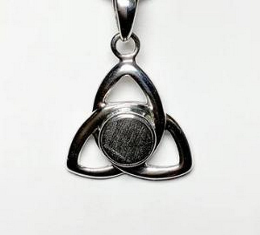 Muonionalusta Meteorite Set In Sterling Silver Celtic Knot Pendant: Muonionalusta Meteorite Set In Sterling Silver Celtic Knot Pendant. Ancient and awe-inspiring, this pendant carries the energy of the cosmos. Estimated to be over 4.5 billion years old (and is believ
