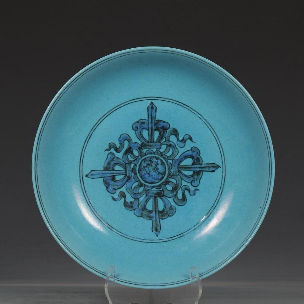 Peacock Blue Plate: Peacock Blue Plate This striking porcelain plate is finished in a vibrant peacock blue glaze, a tone highly prized for its depth and luminosity. A captivating piece, this plate embodies the bold