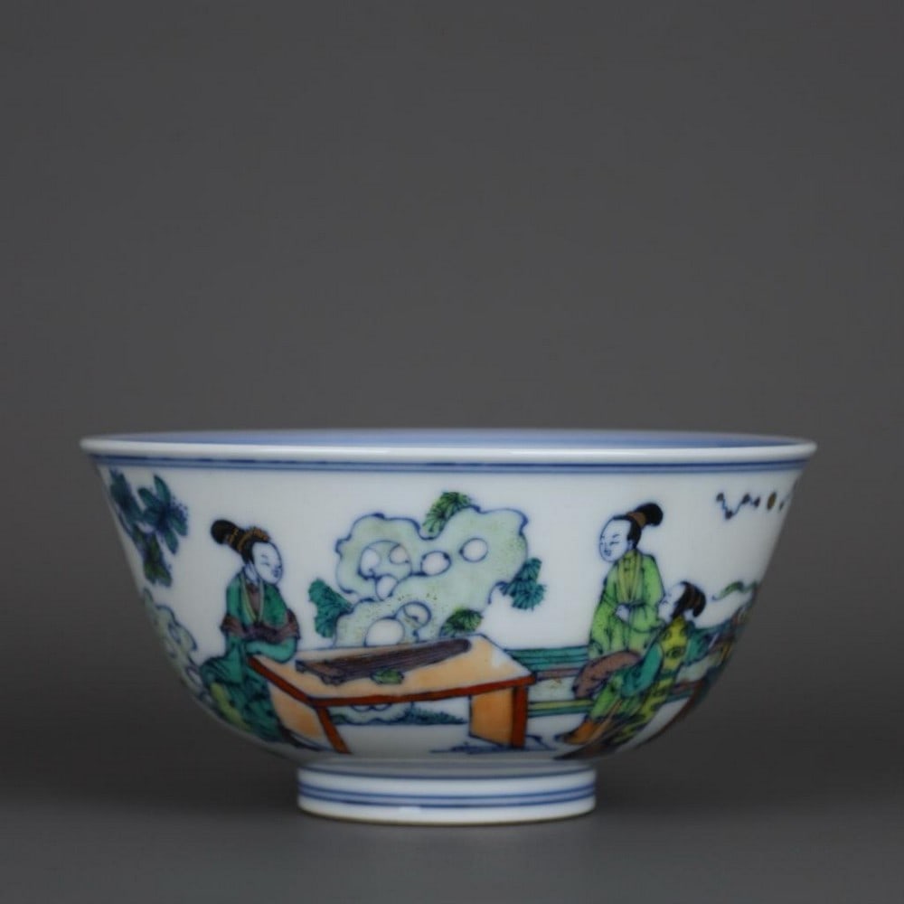Doucai Ladies-at-Leisure Bowl with Kangxi Mark: Doucai Ladies-at-Leisure Bowl with Kangxi Mark A graceful porcelain bowl decorated in the doucai technique inspired by the Qing dynasty , depicting an elegant scene of courtly ladies at leisure in