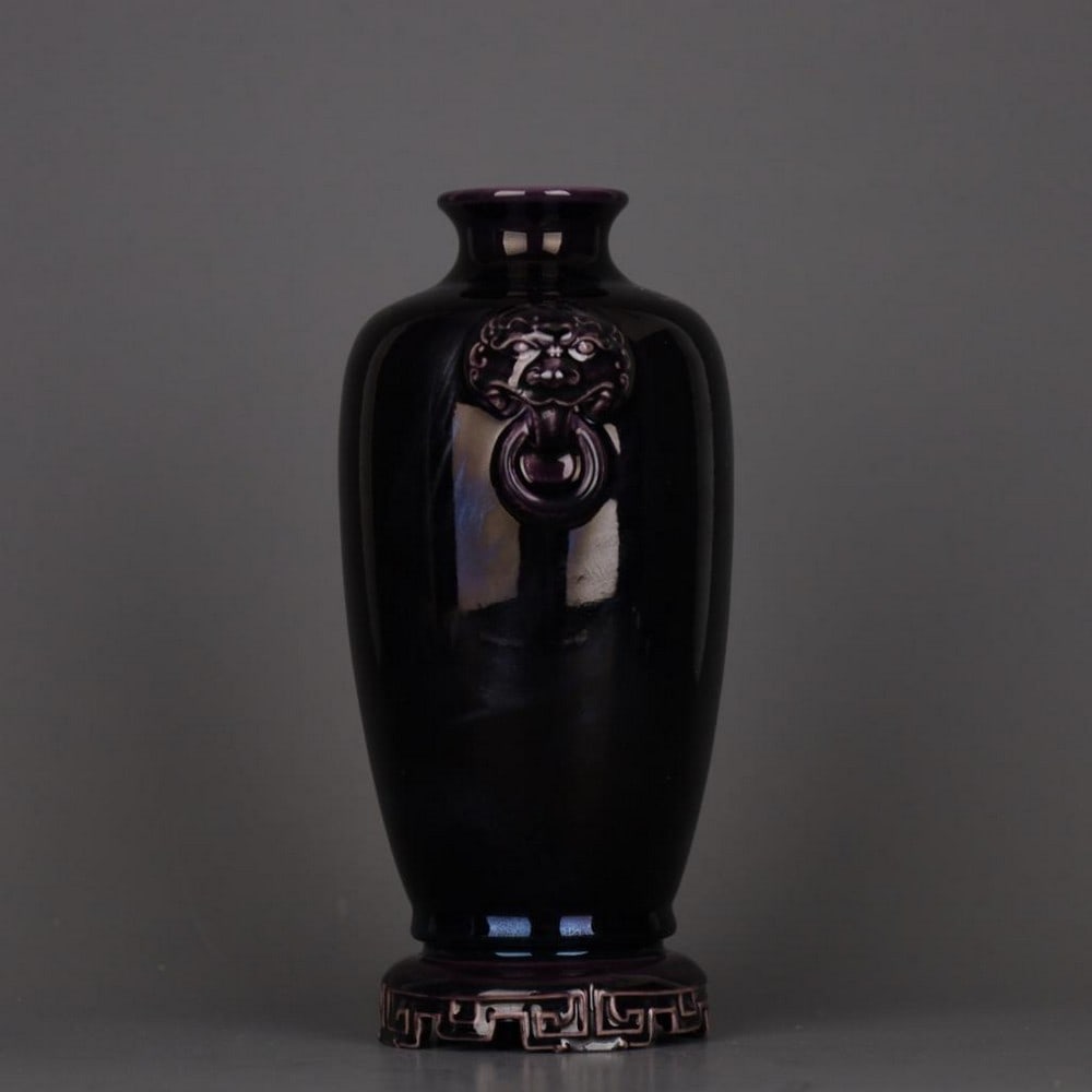 Eggplant Purple Glazed Animal-Handled Bottle with Qianlong Mark: Eggplant Purple Glazed Animal-Handled Bottle with Qianlong Mark An exquisite porcelain bottle with a deep eggplant purple glaze, featuring refined animal-form handles at the neck inspired by the Qing