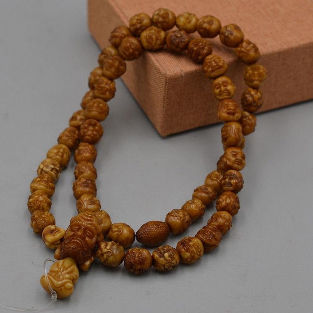 Old Walnut Carving Eighteen Luo Hans' Heads Necklace: Old Walnut Carving Eighteen Luo Hans' Heads Neaklace An intricate necklace featuring the heads of the Eighteen Luo Hans (Arhats), masterfully carved from old walnut wood. Each bead captures uniqu