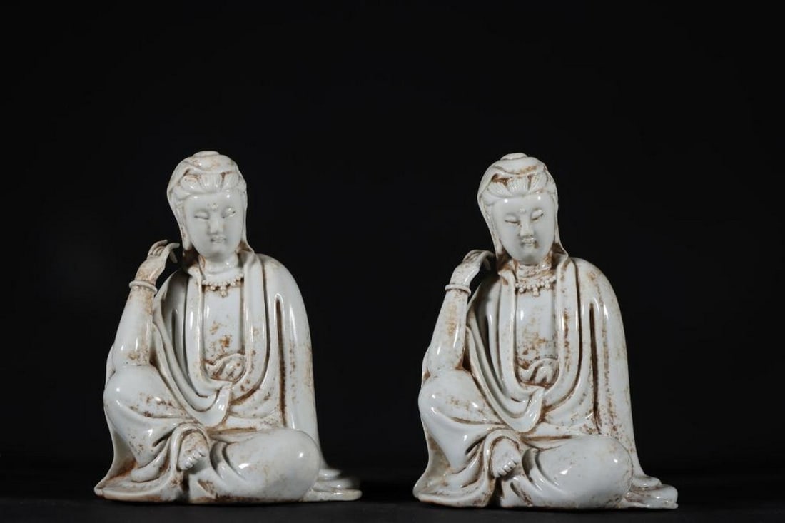 A Pair Of Dehua Kiln Guanyin Statues: A Pair Of Dehua Kiln Guanyin Statues. This exquisite pair of Guanyin statues originates from the renowned Dehua kilns in Fujian, China, celebrated for their fine white porcelain known as "blanc d