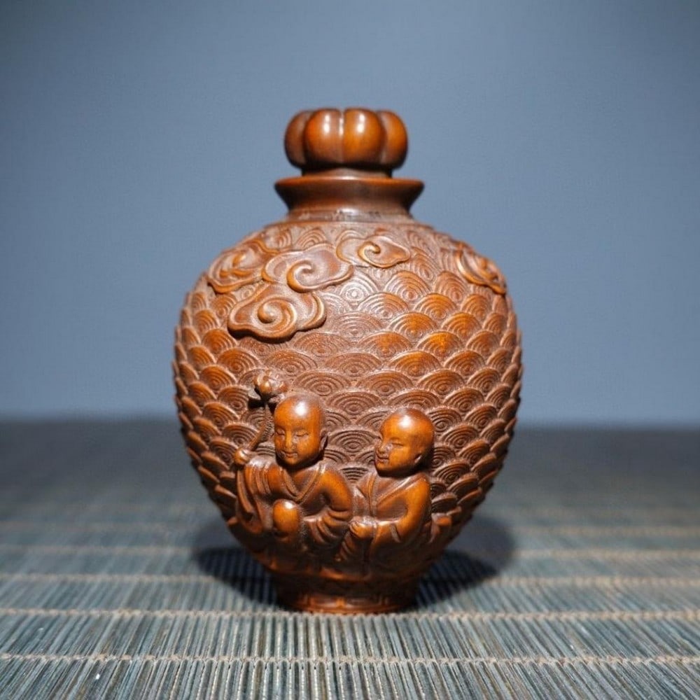 Antique Boxwood Snuff Box with Carving of Two Seated Children: Antique Boxwood Snuff Box with Carving of Two Seated Children This antique boxwood snuff box features an intricate carving of two seated children, showcasing remarkable craftsmanship and attention to