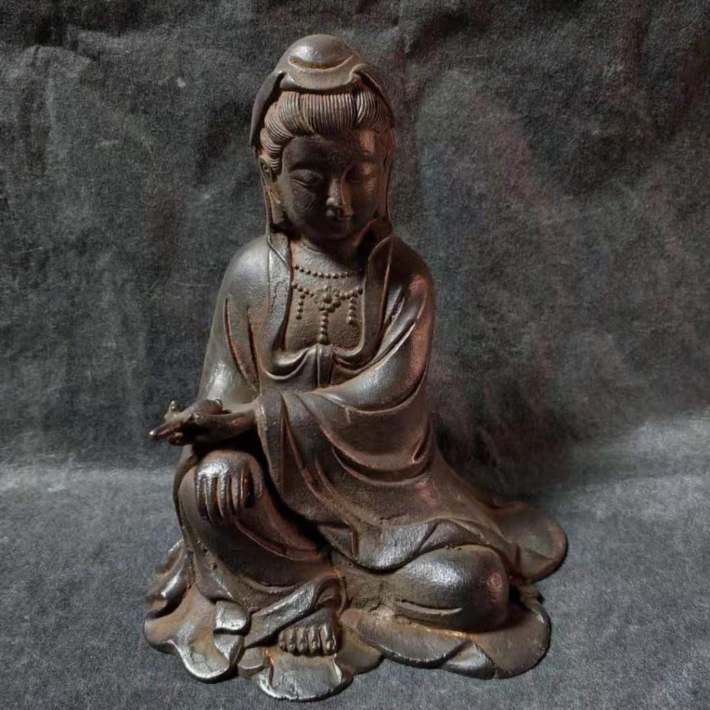 Antique Ironware South Sea Guanyin Statue: Antique Ironware South Sea Guanyin Statue This antique ironware statue features South Sea Guanyin, the bodhisattva of compassion, depicted in a serene and graceful pose. Crafted from durable ironware,