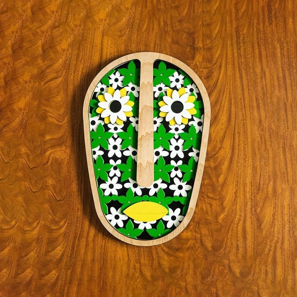 Hand-Carved Wooden Mask with Painted Floral Accents: Hand-Carved Wooden Mask with Painted Floral Accents Bring a touch of nature’s beauty into your space with this exquisite hand-carved wooden mask, adorned with delicately painted floral motifs. Craft