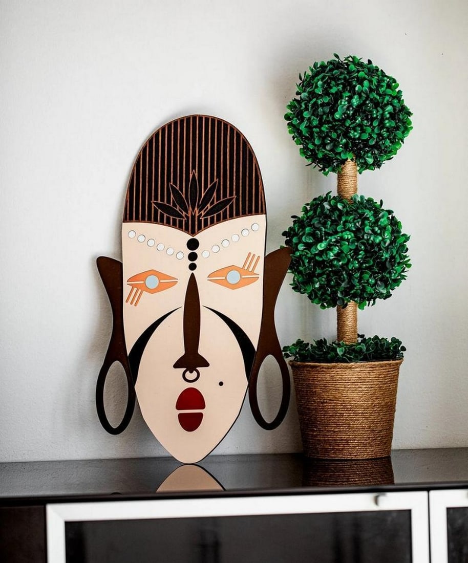 Hand Carved African Tribal Mask Wall Decor: Hand Carved African Tribal Mask Wall Decor Enter a world where artistry and heritage intertwine with this handcrafted African Queen wooden wall mask. More than just décor, this exquisite piece honors