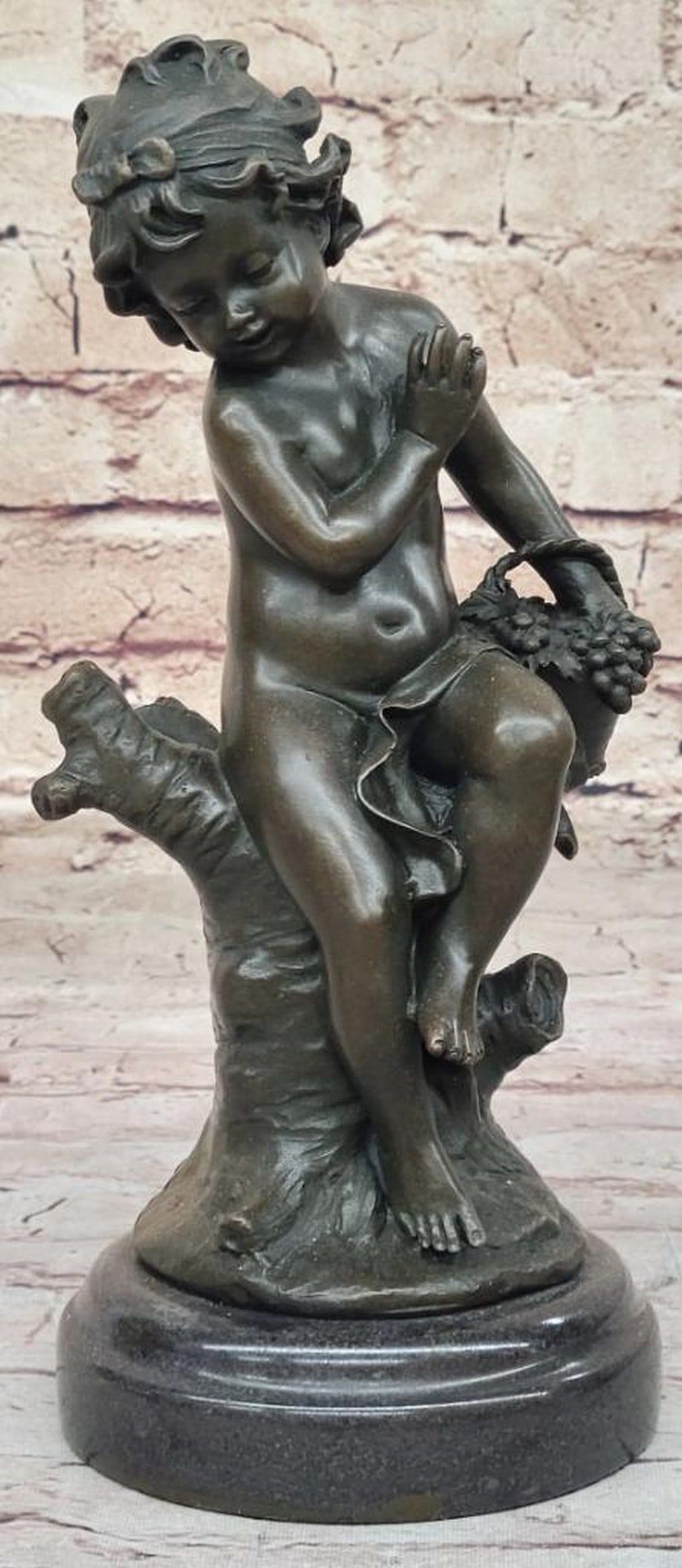 Toddler Holding Basket of Grapes Inspired Bronze Statue - 10" x 5": Toddler Holding Basket of Grapes Inspired Bronze Statue - 10" x 5" This bronze statue by Moreau depicts a young girl standing peacefully with a fruit basket, capturing the innocence and simpl